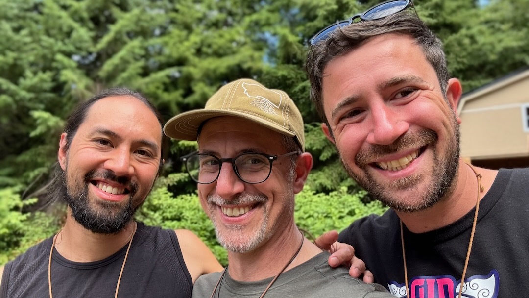 Men from the MKP Portland community smiling together outdoors